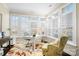 Sunroom office features window shutters and comfortable seating at 19411 Greentree Way, Cornelius, NC 28031