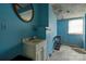 Bathroom featuring a white vanity, shower, blue walls and damaged ceiling at 2021 Willis Dr, Shelby, NC 28152