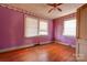 Bedroom with pink walls, wood floors, and visible damage at 2021 Willis Dr, Shelby, NC 28152