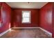 Empty room with hardwood flooring, one window, and blank walls ready for renovation at 2021 Willis Dr, Shelby, NC 28152
