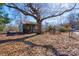 View of the property showcasing a quaint screened porch surrounded by mature trees and foliage at 2021 Willis Dr, Shelby, NC 28152