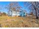 Exterior view of blue home with mature trees and lawn at 2021 Willis Dr, Shelby, NC 28152