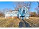 Rear exterior of a blue home with an air conditioning unit and a brick foundation at 2021 Willis Dr, Shelby, NC 28152
