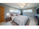 Comfortable main bedroom with a large bed, side tables, and ample natural light provides a serene retreat at 20329 Efird Rd, Albemarle, NC 28001