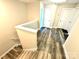 Upstairs hallway with light wood flooring and access to bedrooms at 212 Old Centergrove Rd # 111, Kannapolis, NC 28083