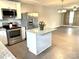Open kitchen with island, stainless steel appliances, and light gray flooring at 212 Old Centergrove Rd # 111, Kannapolis, NC 28083