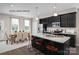 Eat-in kitchen with island seating and modern dark cabinetry at 2509 Ellen Ave # 1015A, Charlotte, NC 28208