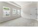 A bright bedroom with three windows offers lots of natural light and plush carpeting at 3036 Arbor Ash St # 1022B, Charlotte, NC 28208