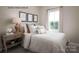Second bedroom with striped bedding and a window with a view at 3036 Arbor Ash St # 1022B, Charlotte, NC 28208