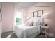 Bright bedroom with a queen bed and window at 3036 Arbor Ash St # 1022B, Charlotte, NC 28208