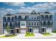 Townhome exteriors feature blue siding, black shutters, white garage doors, and manicured lawns at 3036 Arbor Ash St # 1022B, Charlotte, NC 28208