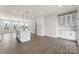 A spacious kitchen features an island with seating and a dining area with modern lighting at 3036 Arbor Ash St # 1022B, Charlotte, NC 28208