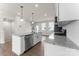 A sleek kitchen showcases an island, modern appliances, white cabinets, and hardwood floors at 3036 Arbor Ash St # 1022B, Charlotte, NC 28208
