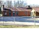 Exterior back of brick home showcasing the fenced backyard and patio at 308 N Hawthorne St, Mount Holly, NC 28120
