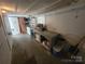 Versatile basement area featuring a long counter, shelves, and extra storage at 308 N Hawthorne St, Mount Holly, NC 28120