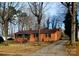 Charming brick ranch-style home featuring a well-manicured lawn and a long driveway at 308 N Hawthorne St, Mount Holly, NC 28120