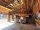 Spacious garage interior with storage shelving and workbench areas; ideal for projects at 308 N Hawthorne St, Mount Holly, NC 28120