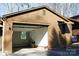 Attached one-car garage with an open door provides convenient parking and storage at 308 N Hawthorne St, Mount Holly, NC 28120