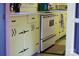 Eat-in kitchen with vintage cabinets and modern white appliances at 308 N Hawthorne St, Mount Holly, NC 28120
