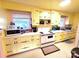 Well-lit kitchen with ample cabinet space, updated appliances, and a clean, functional layout at 308 N Hawthorne St, Mount Holly, NC 28120