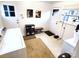 Functional laundry area featuring machines, storage, and natural light at 308 N Hawthorne St, Mount Holly, NC 28120