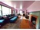 Open-concept living room with fireplace, hardwood floors, and an adjoining dining area at 308 N Hawthorne St, Mount Holly, NC 28120