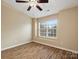 Bedroom with wood floors, window with blinds, and ceiling fan at 3100 Windsor Trace Dr, Fort Mill, SC 29707