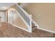 Well-lit staircase with white railings and wood flooring at 3100 Windsor Trace Dr, Fort Mill, SC 29707