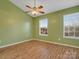 Spacious bedroom with hardwood floors, ceiling fan and green walls at 3102 Windsor Trace Dr, Fort Mill, SC 29707