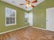 Bright bedroom with wood floors, ceiling fan, and window blinds at 3102 Windsor Trace Dr, Fort Mill, SC 29707