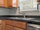 Modern kitchen sink with stylish faucet and dark countertop at 3102 Windsor Trace Dr, Fort Mill, SC 29707