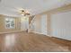 Living room with hardwood floors, ceiling fan, and stairs at 3102 Windsor Trace Dr, Fort Mill, SC 29707