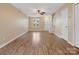Living room with wood floors, ceiling fan and access to the stairs at 3102 Windsor Trace Dr, Fort Mill, SC 29707
