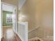 Upstairs hallway with hardwood floors and white railing at 3102 Windsor Trace Dr, Fort Mill, SC 29707