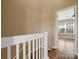 Upstairs hallway with white railing and view of bedroom at 3102 Windsor Trace Dr, Fort Mill, SC 29707