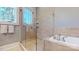 Spa-like bathroom with a glass shower and soaking tub at 3238 Park Rd, Charlotte, NC 28209