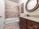 Cozy bathroom with a granite vanity, oval mirror, and tiled shower and tub at 3850 Hounslow Ln, Harrisburg, NC 28075