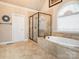 Bright bathroom featuring a glass shower, garden tub, and natural light at 3850 Hounslow Ln, Harrisburg, NC 28075