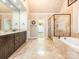 Bright bathroom with a double sink vanity, soaking tub, and glass enclosed shower at 3850 Hounslow Ln, Harrisburg, NC 28075
