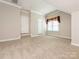 Spacious carpeted bedroom with white trim and doors, and a window with decoractive valance at 3850 Hounslow Ln, Harrisburg, NC 28075