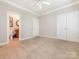 Spacious bedroom with neutral carpet and two closets, with an ensuite bathroom at 3850 Hounslow Ln, Harrisburg, NC 28075