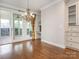 Open dining room with wood floors, chandelier, and sliding glass doors leading to an outdoor patio at 3850 Hounslow Ln, Harrisburg, NC 28075