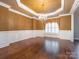 Elegant dining room featuring decorative molding, a chandelier, and hardwood flooring at 3850 Hounslow Ln, Harrisburg, NC 28075