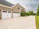 Brick home featuring a three-car garage, manicured landscaping, and an inviting front entrance at 3850 Hounslow Ln, Harrisburg, NC 28075