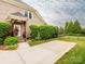 Charming brick home with a welcoming front porch, lush greenery, and well-maintained landscaping at 3850 Hounslow Ln, Harrisburg, NC 28075