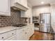 Spacious kitchen featuring stainless steel appliances, granite countertops, and a dark subway tile backsplash at 3850 Hounslow Ln, Harrisburg, NC 28075
