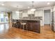 Kitchen island with bar stools, stainless steel appliances, and ample counter space at 3850 Hounslow Ln, Harrisburg, NC 28075