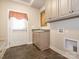 Mudroom featuring a utility sink with shaker cabinets and a door to the exterior at 3850 Hounslow Ln, Harrisburg, NC 28075