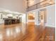 Bright, open-concept living area with hardwood floors, kitchen access, and natural light at 3850 Hounslow Ln, Harrisburg, NC 28075