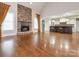 Open concept living space with a stone fireplace and a view of the kitchen with bar seating at 3850 Hounslow Ln, Harrisburg, NC 28075